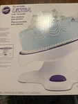 Wilton Tilt-n-turn Ultra Cake Turntable Stand 12", White, Purple New. Price: $74.95.